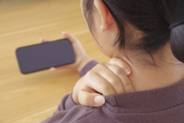スマホ首の女性